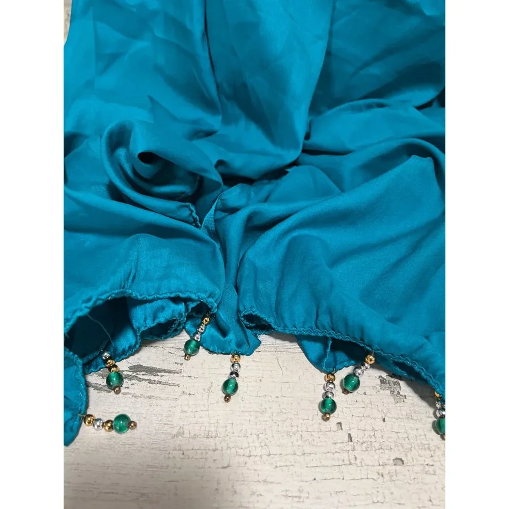Teal colored shawl wrap with teal, silver, and gold beads on ends